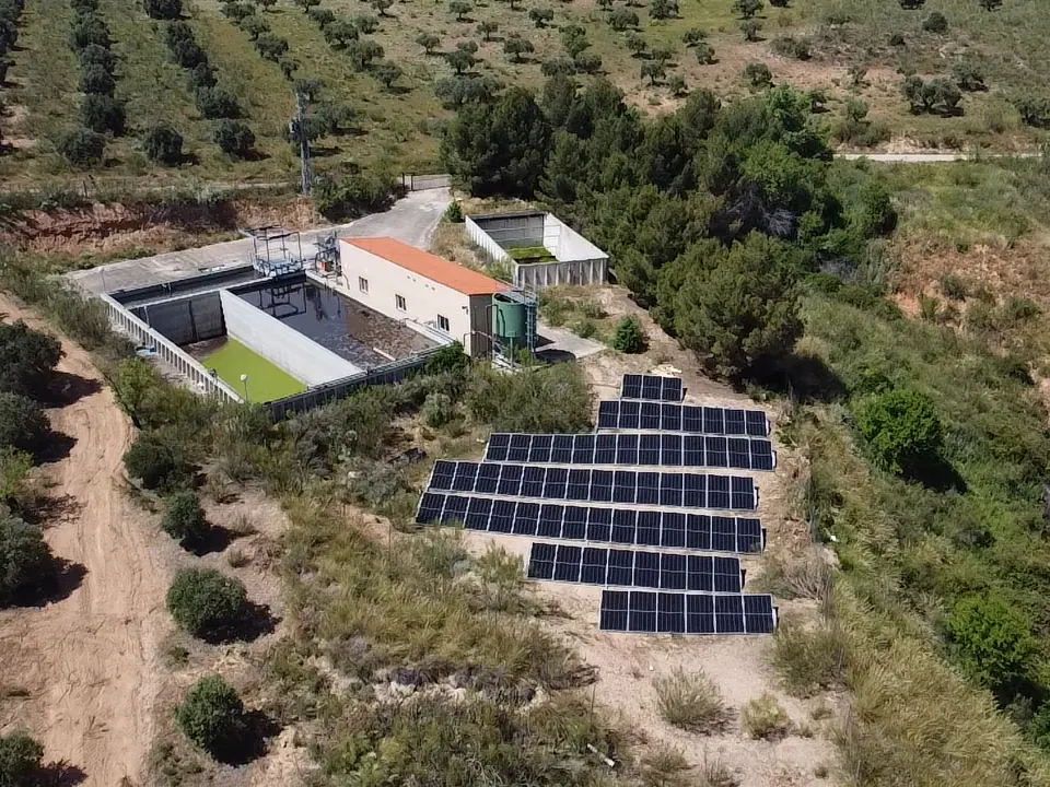 Campo fotovoltaico junto a unos depósitos de tratamiento de agua